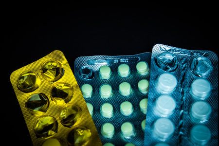 Pills in blisters pack over black background