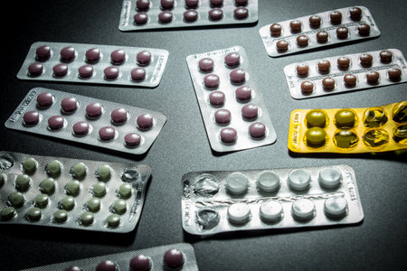 Pills in blister packs over black backgroundの写真素材
