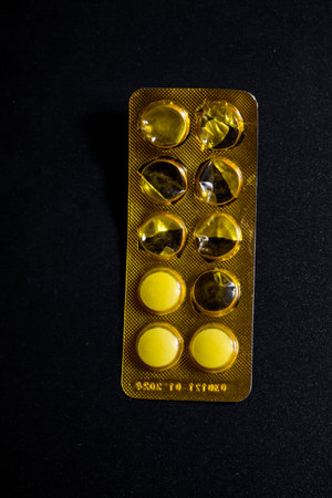Pills in blister pack over black background