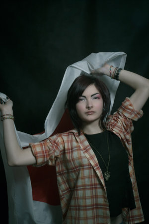 Pretty asian girl with japanese flag over dark backgroundの写真素材