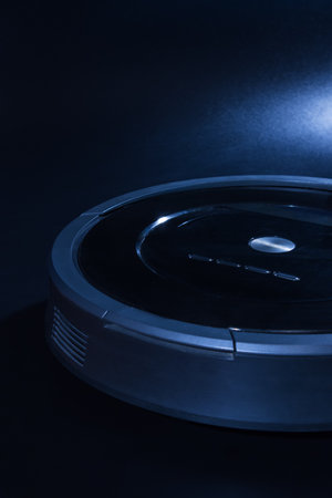 Robot vacuum cleaner over black backgroundの写真素材