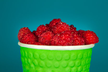 Fresh Raspberry over blue background