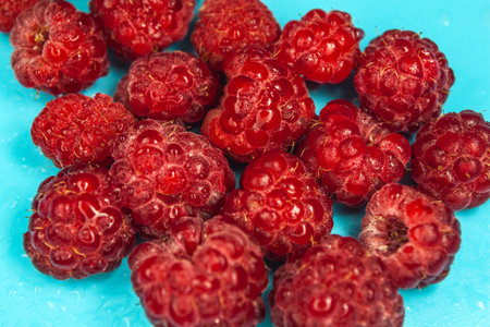 Fresh raspberry over blue background