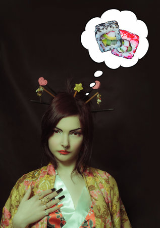 Pretty geisha in kimono posing over dark backgroundの写真素材