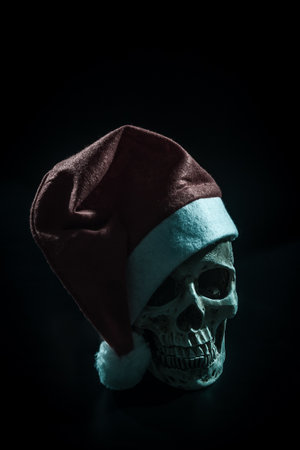 Santa skull in snow over dark background.の写真素材
