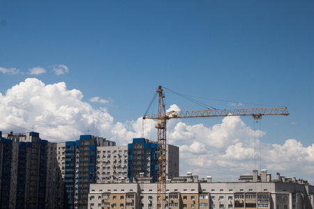 Silhouette of tower crane over skyの写真素材