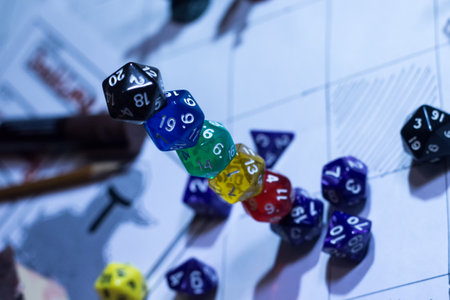 A vertical arrangement of several twenty-sided dice (D20) carefully stacked on top of each other,...