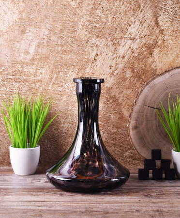 black bulb on gold background with green grass and coconut charcoalの写真素材