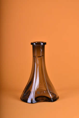 black glass bulb on orange backgroundの写真素材