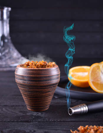 hookah bowl with tobacco on a dark backgroundの写真素材