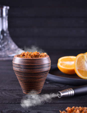hookah bowl with tobacco on a dark backgroundの写真素材