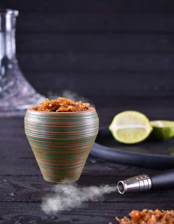 hookah bowl with tobacco on a dark backgroundの写真素材