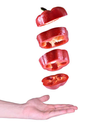 flying red pepper with water drops on white backgroundの写真素材