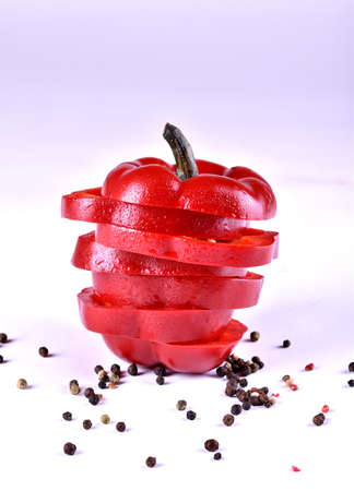 chopped red pepper with water drops on white backgroundの写真素材