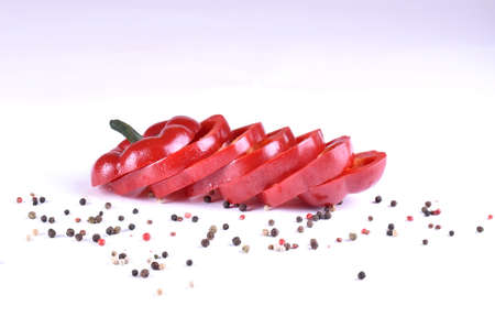 chopped red pepper with water drops on white backgroundの写真素材