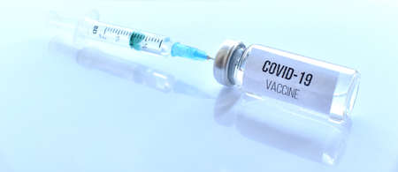 Covid-19 vaccine and syringe.の写真素材