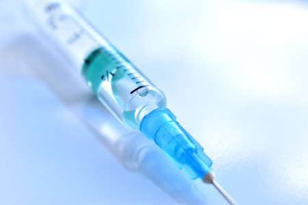Medical syringe with a vaccine. Epidemic. Blood collection and injection conceptの写真素材