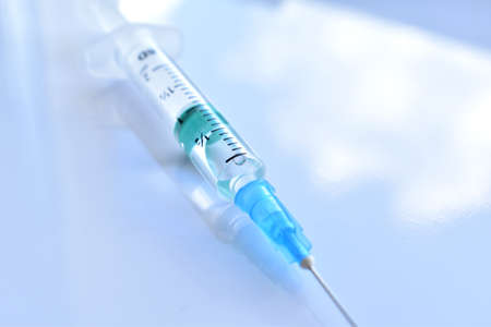 Medical syringe with a vaccine. Epidemic. Blood collection and injection conceptの写真素材