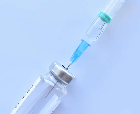 Vaccine against covid-19 and a syringe with a vaccine. Isolateの写真素材