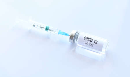 Vaccine against covid-19 and a syringe with a vaccine.の写真素材