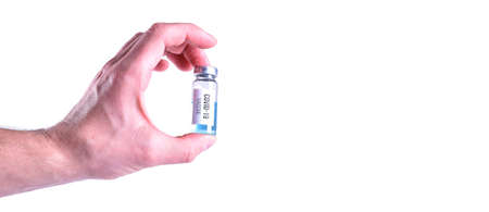 Covid-19 vaccine in hand on white background with place for textの写真素材