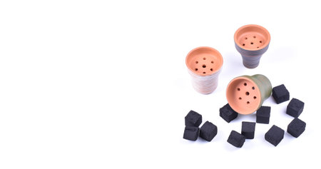 Hookah bowls with tobacco and charcoal for smoking on a white background. Space for text. Bannerの写真素材