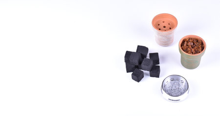 Hookah bowls with tobacco and charcoal for smoking on a white background. Space for text. Bannerの写真素材