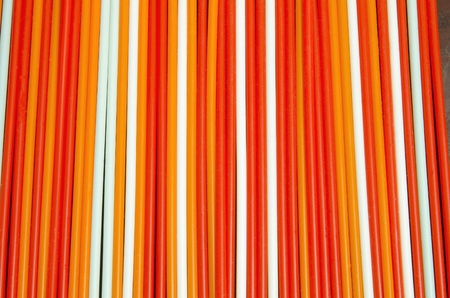 Multicolored tubes for drinking beverages, laid out the background.の写真素材