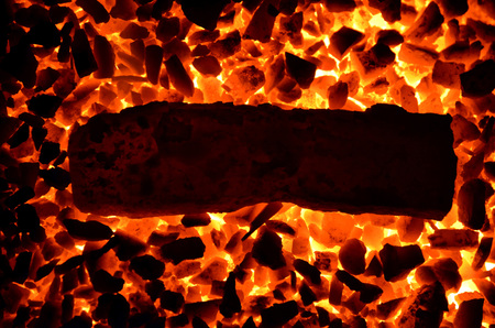 A long piece of hot iron lies on a burning corner.の写真素材