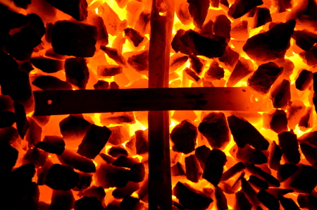 An incandescent cross created from two metal slats.の写真素材