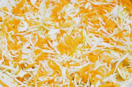 A background of sliced ??juicy cabbage and carrots.の写真素材