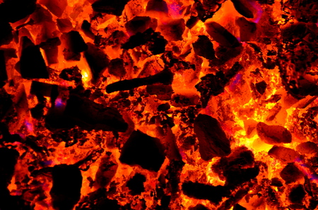 Bright background consists of burning coal, wood and non-ferrous metal.