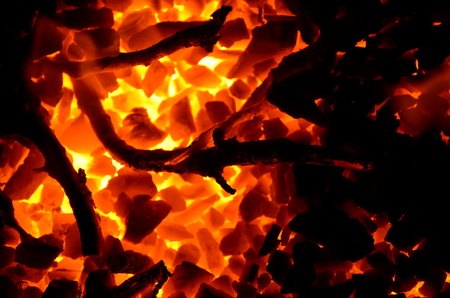 A background of burning and non-burning coal and wood.