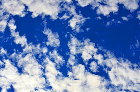 A blue sky with a lot of small clouds.