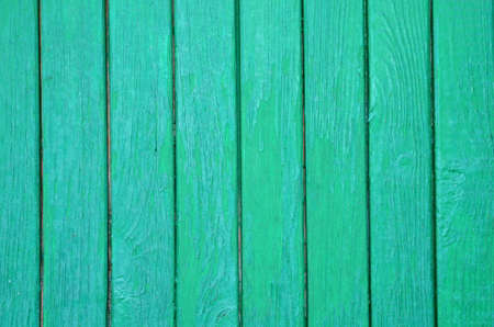 The graphic resource consists of vertical wooden planks in green paint.の写真素材