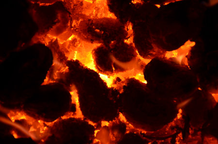 The background consists of a burning mass of coal and wood.の写真素材