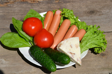 A plate with a delicious dish stands on a wooden table.の写真素材