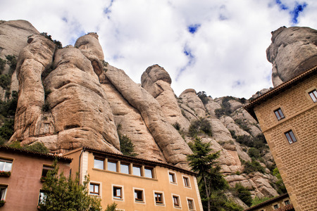Santa Maria de Montserrat Abbey in Monistrol de Montserrat, Catalonia, Spain. Famous for the Virgin of Montserrat. View to mountains.の写真素材