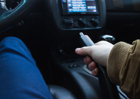 Closeup view of man pulling handbrake lever in carの写真素材