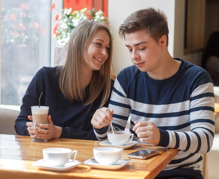 Cheerful couple dating in a cafe.  They look happyの写真素材