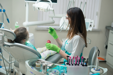 Female Dentist checking little girl patientの写真素材