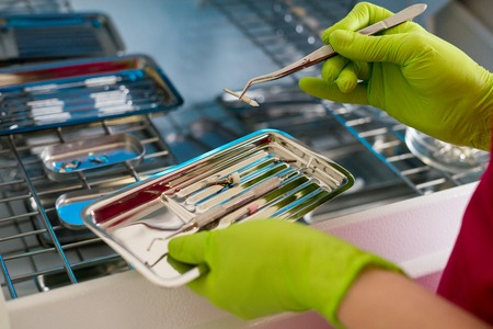 dentist hands holding dental instrumentsの写真素材