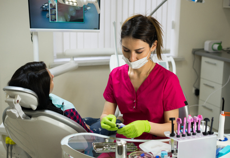 dentist at work preparing instrumentsの写真素材