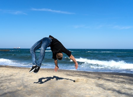 young parkour man doing flip or somersaultの写真素材
