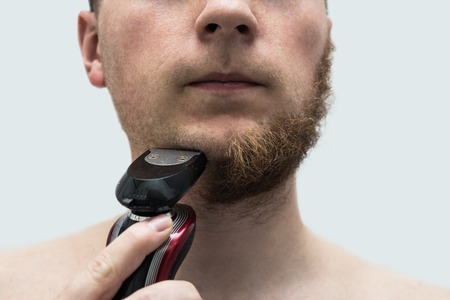 young man shaving his beard offの写真素材