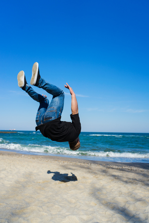 young parkour man doing flip or somersaultの写真素材