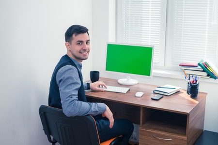 Happy office worker smiling and looking at the cameraの写真素材