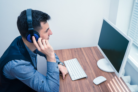 handsome man in call center with headphonesの写真素材