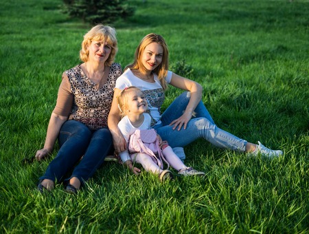 Happy Mother and daughter smiling at the park having picnicの写真素材