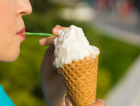 Happy sexy woman eating ice creamの写真素材